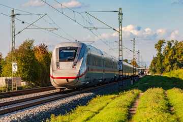 A rail track on which an high-speed intercity train passing through rural area, Germany