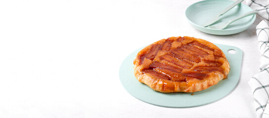Sweet pie with caramelized banana served on green board. Homemade dessert. Web banner with copy space