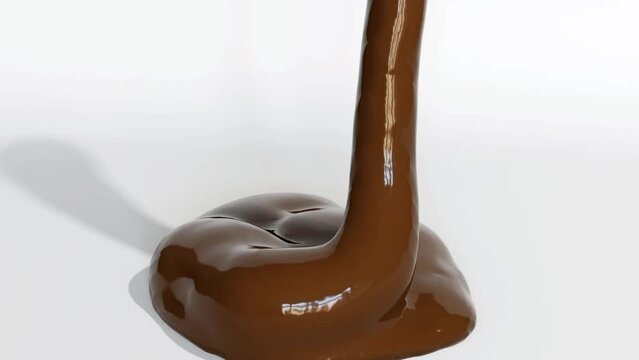 Liquid chocolate flows slowly onto a white surface