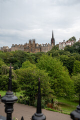 Fototapeta na wymiar View from Princes street to old town and castle in Edinburgh city, view on houses, hills and trees in old part of the city, Scotland, UK