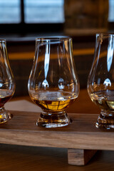 Flight of single malt scotch whisky in glasses served in whiskey bar in Edinburgh, UK