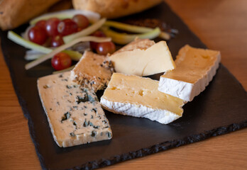 Tasting of farmers scottish cheeses cheddar, stilton, blue cheese, brie in Edinburgh, UK