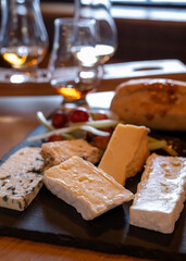 Pairing of scotch whisky and farmers scottish cheeses cheddar, stilton, blue cheese, brie, tasting of whiskey and cheese in Edinburgh, UK