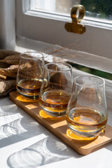 Flight of single malt scotch whisky served on old wooden window sill in Scottisch house in Edinburgh, Scotland, UK