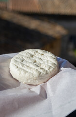 One small fresh white cheese  made in Provence from unpasteurised goat milk