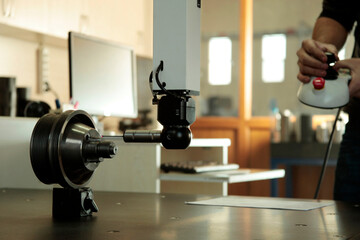 CMM probe measuring on steel cylinder. CMM probe Machine control controller.