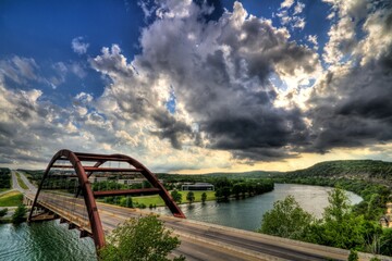 Percy V. Pennybacker Jr. Bridge in Austin, Texas across lake Austin under a cloudy sky