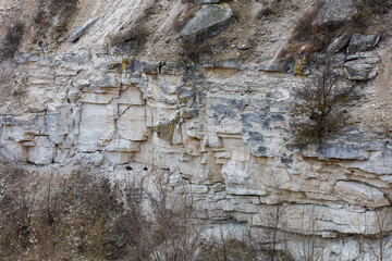 Fototapeta premium Texture cracked rock formation rock in the wild. Background with copy space
