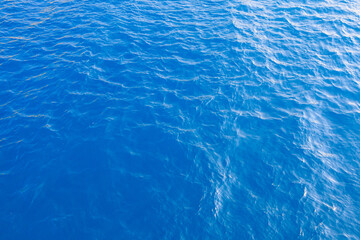 Very nice sea water background or backdrop with selective focus. Small waves of natural water surface texture.
