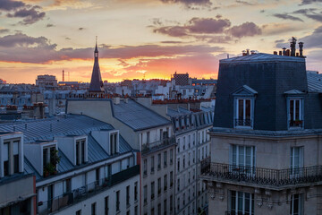 Fototapeta na wymiar street in Paris, rooftops with sunset sky, traditional architecture residential buildings, France