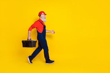 Profile side full size photo of machinist retired workman go construct interior hold toolkit isolated shine color background