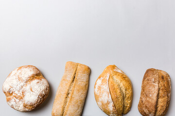 Homemade natural breads. Different kinds of fresh bread as background, top view with copy space