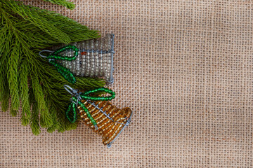 South African Beaded Christmas decorations with tree bits on rustic burlap fabric