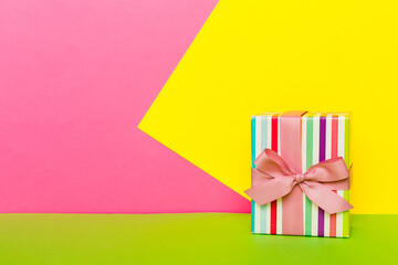 holiday paper present tied pink ribbon bow top view with copy space. Flat lay holiday background....