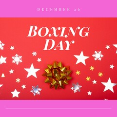 Fototapeta na wymiar Composition of boxing day text over christmas decorations on red background