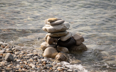 Pyramid of stones on a pebble sea beach.