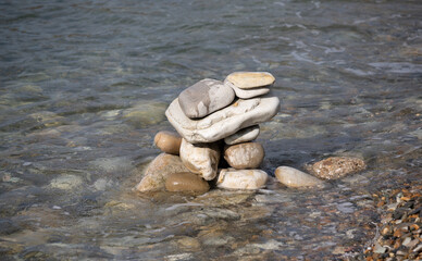 Pyramid of stones on a pebble sea beach.