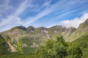 Mountain range and clouds in the sunshine near Orsvag and Vågakallen, Lofoten Islands, Nordland, Norway