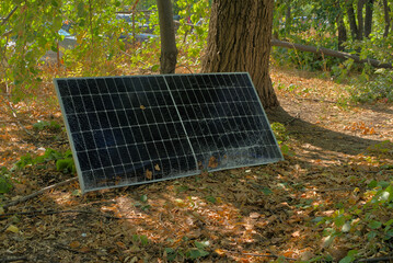 A broken solar panel, a torn panel mount lie on the ground. Consequences of a natural disaster....