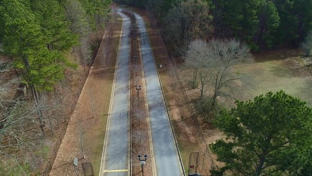 Aerial drone View Flying Over 2 Lane Street Park entrance