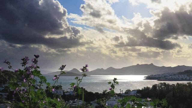 Timelapse of sea, houses, flowers and clouds with overhead view in cloudy and windy weather Bitez, Bodrum.