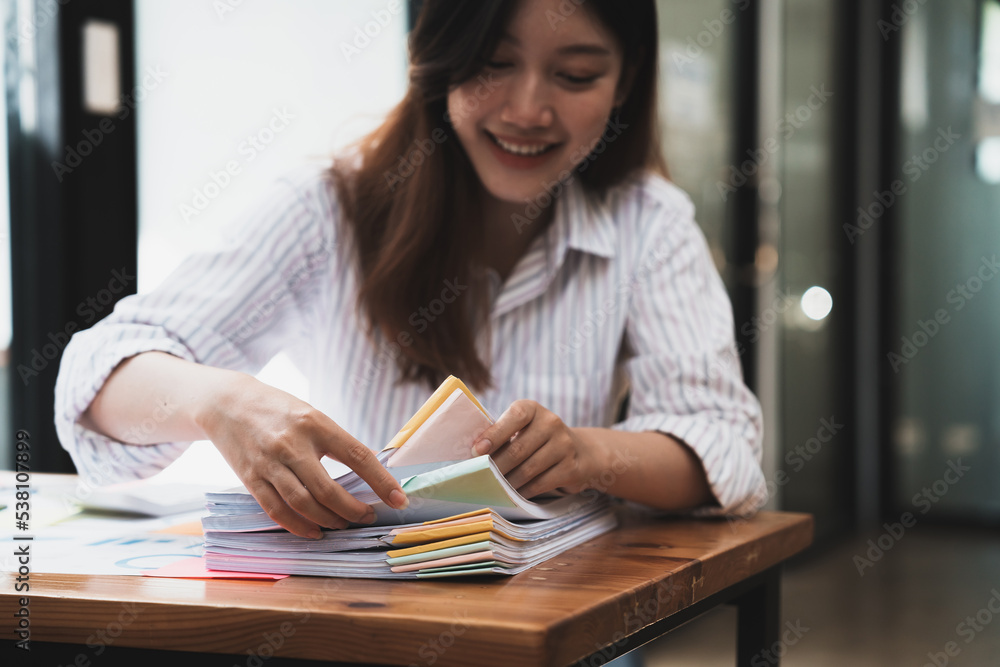 Poster employee woman hands working in stacks paper files for searching and checking unfinished document ac