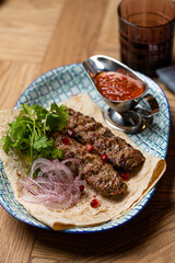 lula kebab on a plate in a restaurant