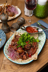 pork skewers on a plate in a restaurant