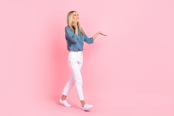 Full body profile photo of nice lady walk speak communicate telephone isolated on pink color background