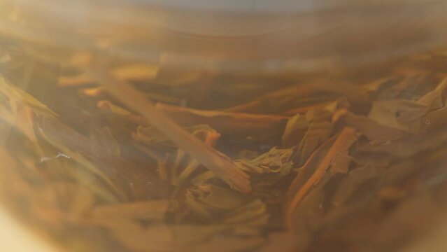 Pressed Pu erh tea fermented aged tea leaves. Macro close up. Brewing tea