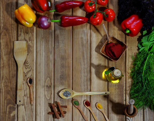 Vegetables, pepper, tomato, wooden spoon and spices on wooden background. table for placing food