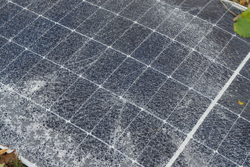 A broken solar panel, a torn panel mount lie on the ground. Consequences of a natural disaster. Green energy and natural conditions