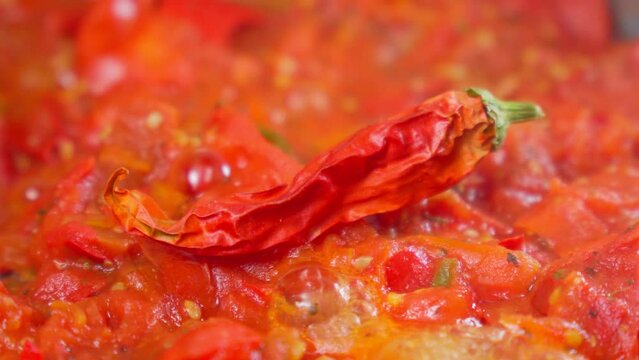 Chili sauce preparation, process of making, close-up, selective focus. Spicy food, red pepper