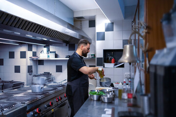 Chef prepares typical dishes for tasting in his restaurant