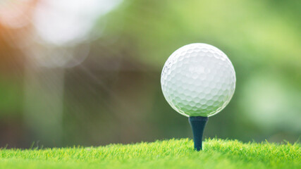 Golf ball on Green field golf course in the morning time with soft sunlight, Sports that people around the world play during the holidays for health.