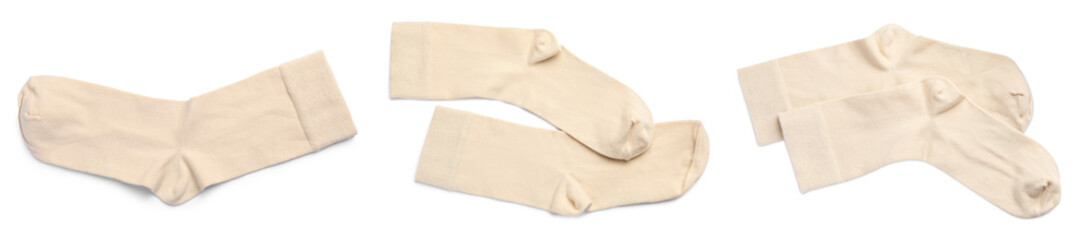 Obraz na płótnie Canvas Set with pairs of beige socks on white background, top view. Banner design