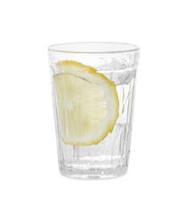 Water with sliced lemon splashing out of glass on white background
