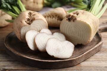 Cut sugar beets on wooden table, closeup