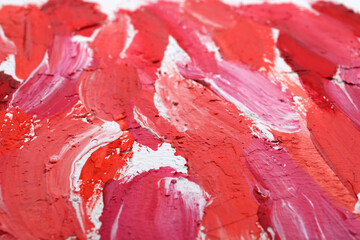 Beautiful strokes of bright oil paints on white canvas as background, closeup