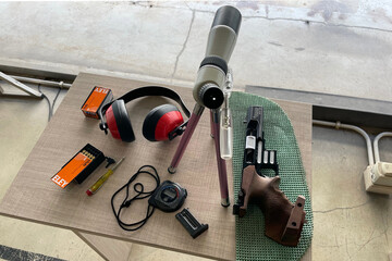 Pistol on the table. Image shows the .22 caliber pistol with Protective ear muffs safety first concepts. shooting competition.