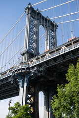 Fototapeta premium Tower of the Manhattan Bridge in Brooklyn, seen from below, in summer