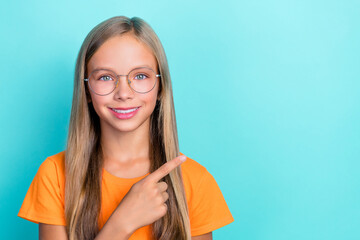 Closeup portrait photo of preteen schoolgirl wear orange t-shirt stylish glasses finger point empty...