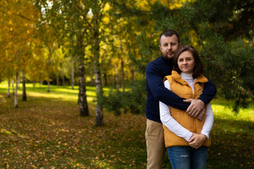 Fototapeta premium happy classic traditional family hugging against autumn forest background