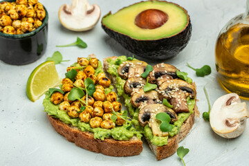 Mashed avocado, mushrooms and chickpea toasts. Delicious breakfast or snack, Clean eating, dieting, vegan food concept. top view