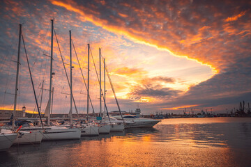 Scenic sunset over luxury yachts and sailing boats in yacht port.  Leisure zone in sea port Varna, Bulgaria
