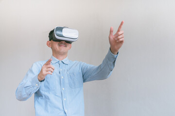 business man using virtual reality headset. Isolated on gray background studio portrait. VR, future, technology, education online, studying .  Studio shot on gray