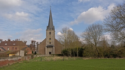 Fototapeta na wymiar Spiennes, small village in the Wallonian countryside, wtih Saint Amand church. Hainaut, Belgium 