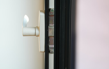 Detail view of an opening handle of a multi-chamber double glazed window, a premium finish found in a luxury home.