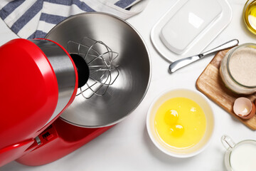 Modern red stand mixer and different ingredients on white table, flat lay