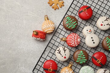 Beautifully decorated Christmas macarons on light grey table, flat lay
